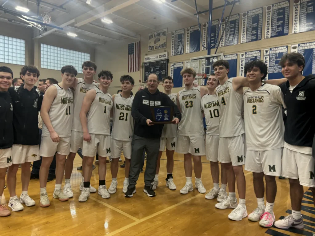 DST Basketball boys team receiving an award plaque